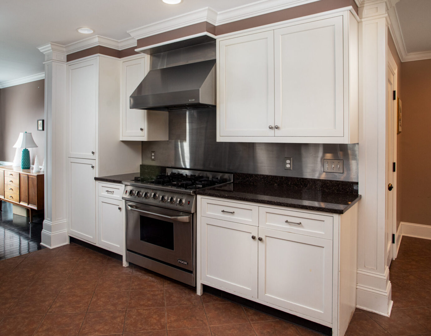 View of kitchen with white cabinet and stove