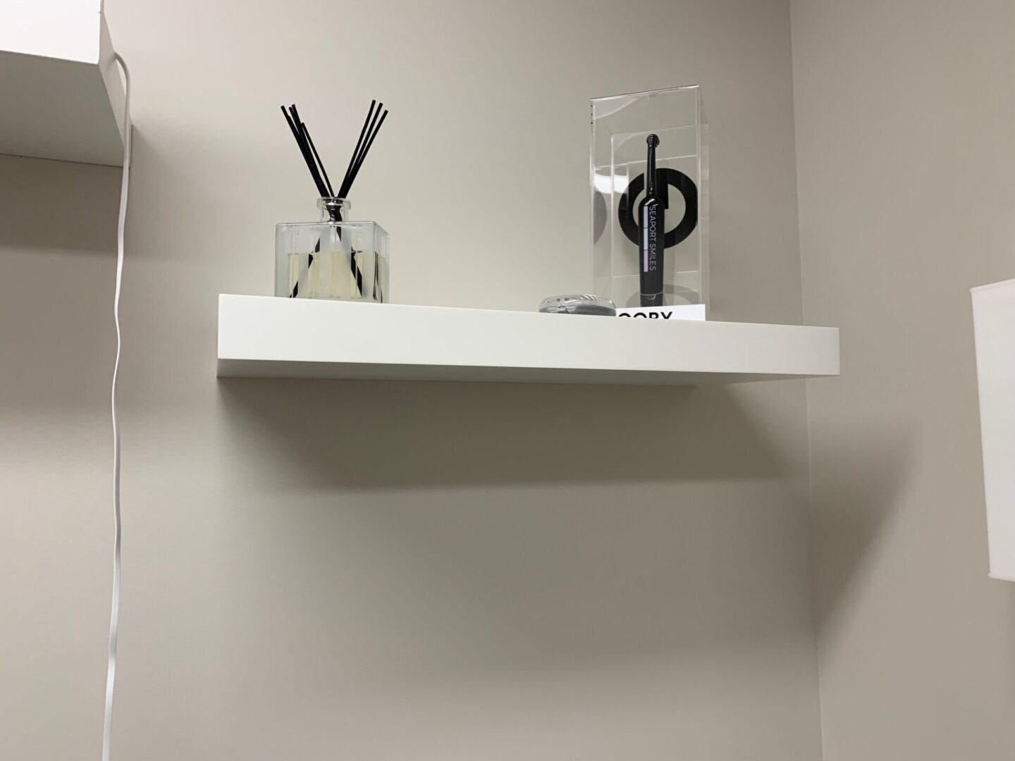 Close view of the wall shelf with two items on it