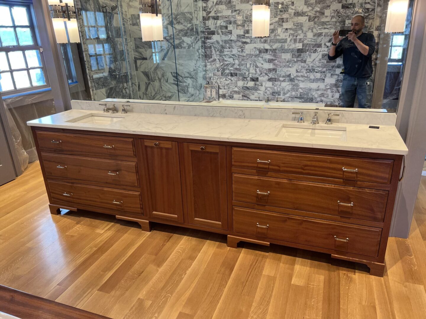 Wash area with mirror and wooden cabinets