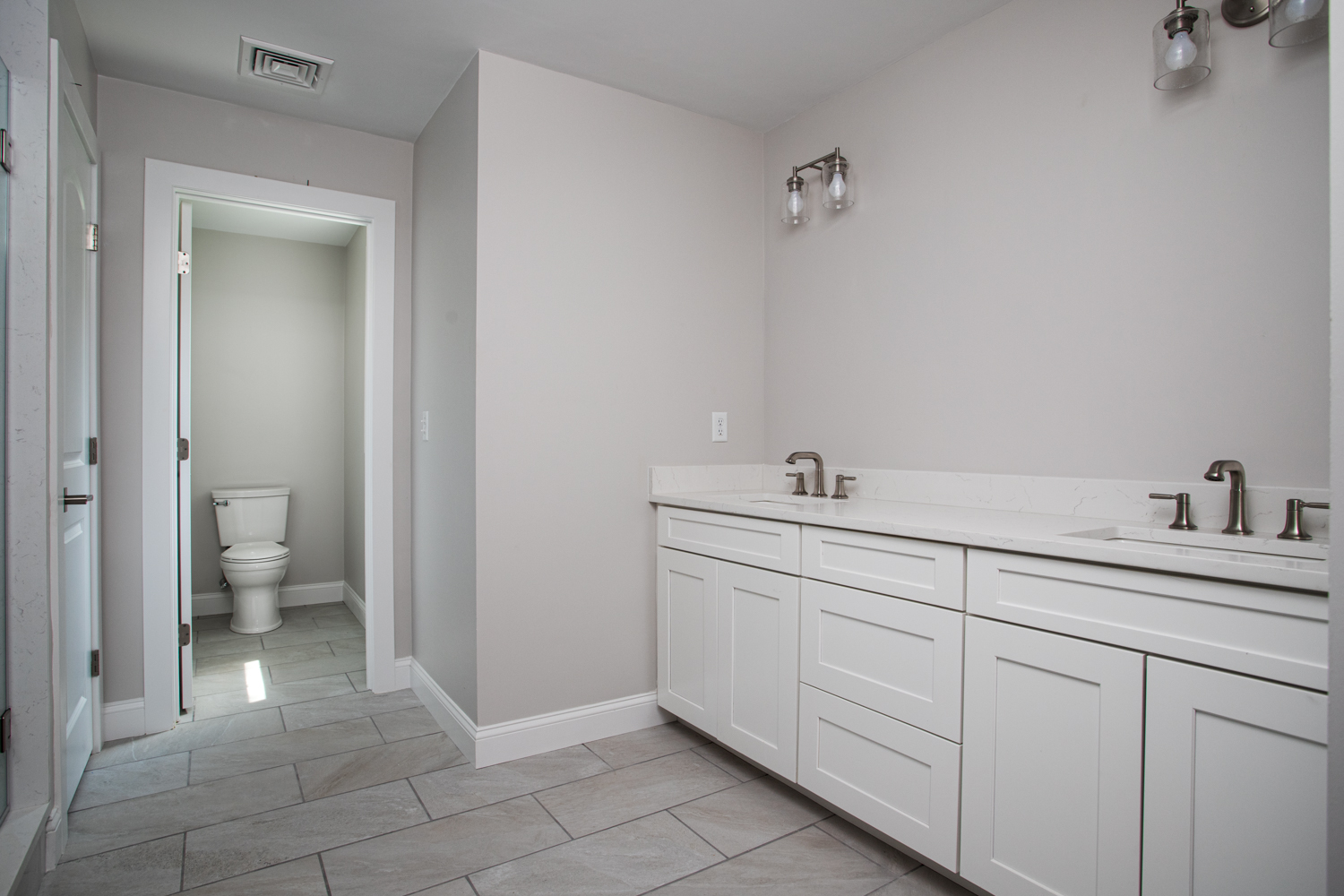 Wash area with white walls and white cabinets